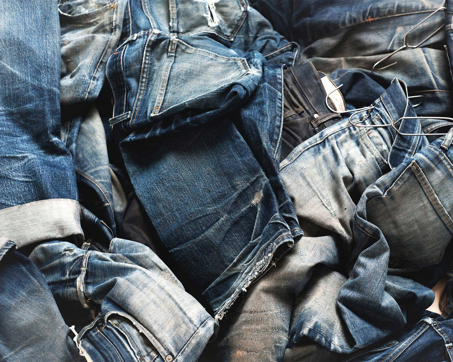 a pile of jeans with a pair of jeans