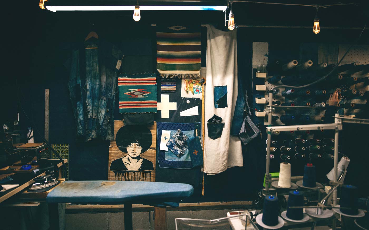 a room with a table and cloths and a ironing board