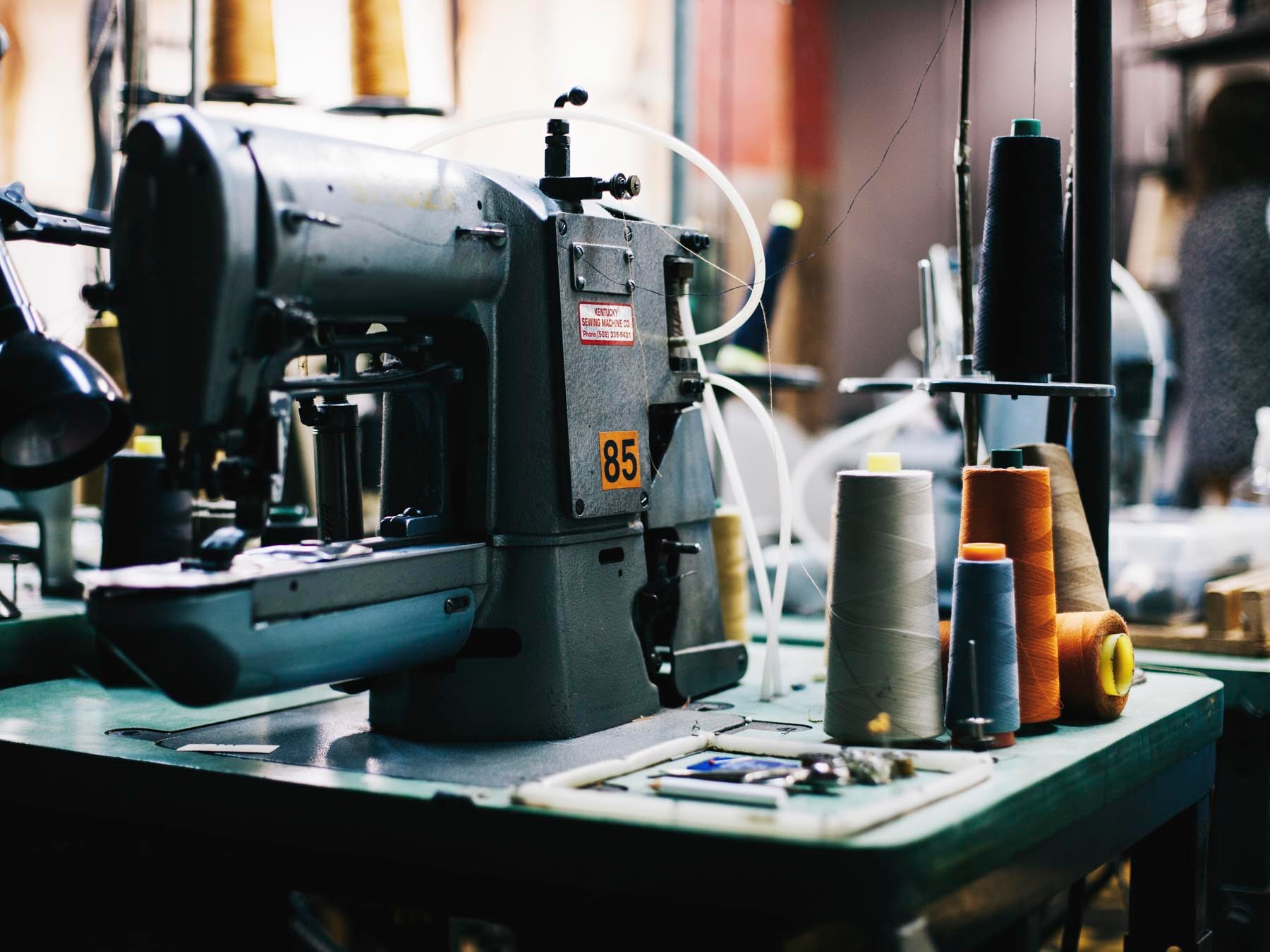 a sewing machine with spools of thread